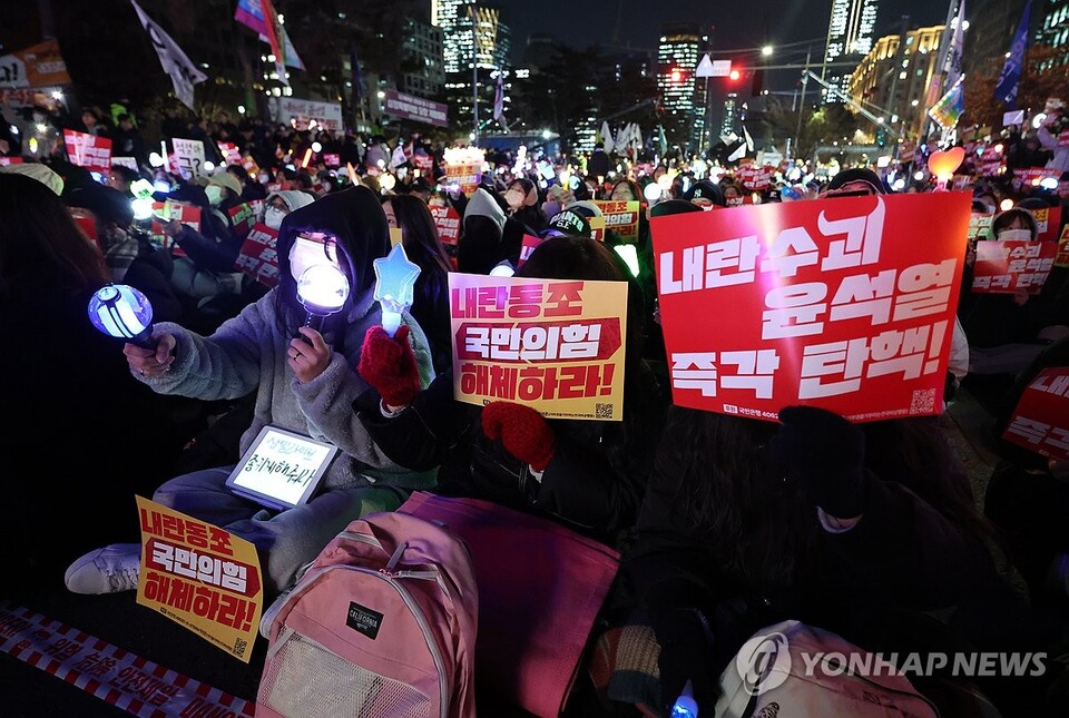 9일 오후 서울 영등포구 국회의사당 앞에서 열린 '윤석열 즉각 탄핵 구속 촉구 촛불문화제'에서 참가자들이 손팻말을 들고 있다.(연합뉴스)