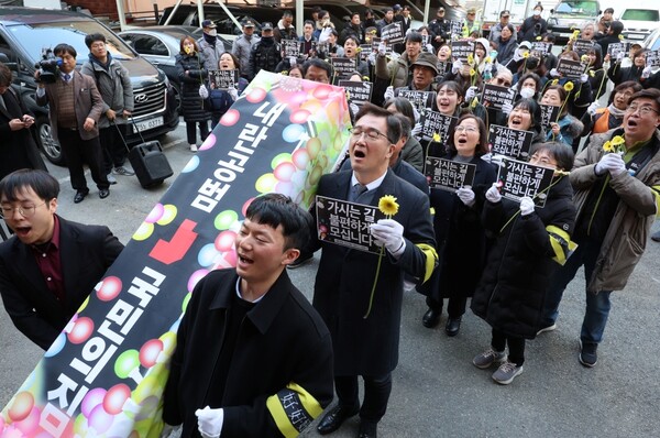 '윤석열정권 퇴진 부산비상행동' 소속 회원들이 11일 오후 부산 수영구 국민의힘 부산시당 앞에서 국민의힘 사망선고 장례식 퍼포먼스를 펼치고 있다 (사진=연합뉴스)