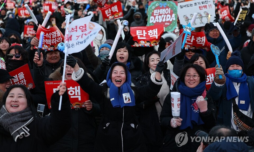 윤석열 대통령 탄핵소추안이 가결된 14일 서울 여의도 국회 앞에서 열린 촛불집회에 참석한 시민들이 탄핵이 가결되자 환호하고 있다. (서울=연합뉴스)