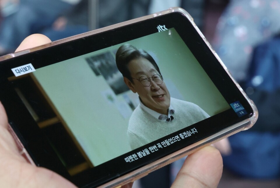 지난 10일 서울역 대합실에서 한 시민이 더불어민주당 이재명 전 대표의 대통령 선거 출마 선언 영상을 지켜보고 있다 (사진=연합뉴스)