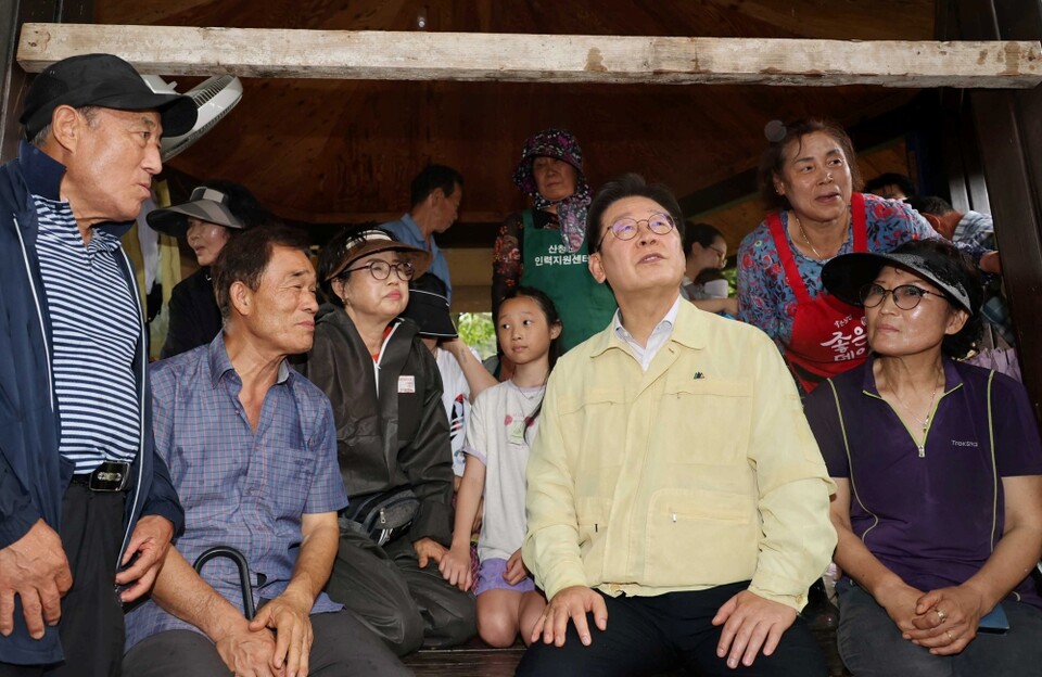 이재명 대통령이 지난 21일 집중호우로 산사태가 발생한 경남 산청군 산청읍 부리마을에서 주민들과 대화하고 있다 (사진=연합뉴스)
